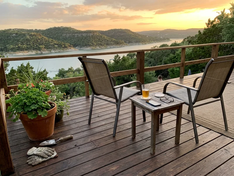 Freshly stained backyard deck with patio chairs overlooking the hills