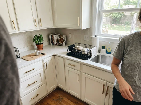 After: the same kitchen with smooth painted cabinets and new hardware
