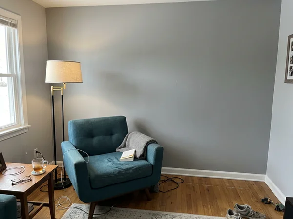 After: the same wall evenly painted with no visible repairs