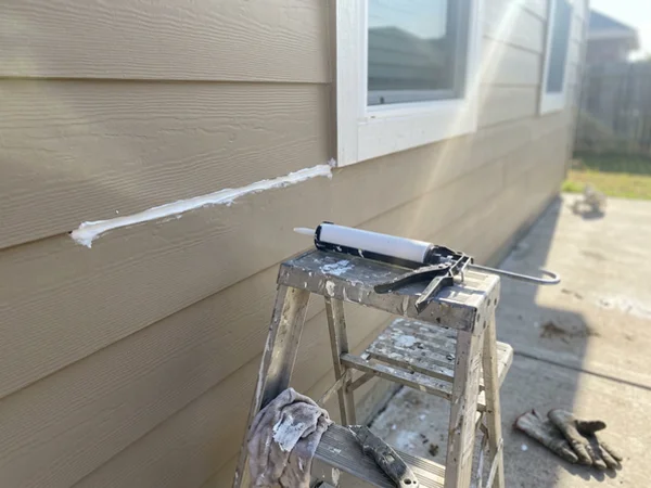 Fresh caulk bead along a siding joint