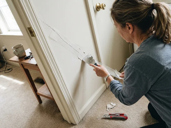 Taping a diagonal crack at a door corner