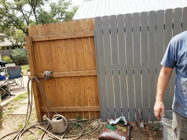 Semi-transparent and solid stain side by side on a fence