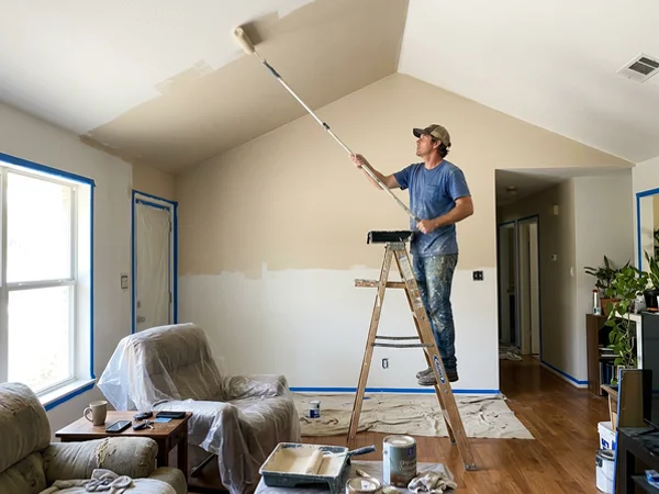 Rolling a vaulted ceiling with an extension pole in a Central Texas home