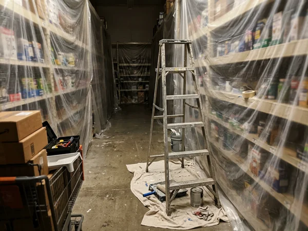 Retail shelves wrapped in plastic for overnight painting