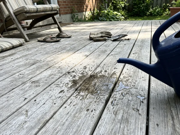 Water soaking into weathered deck boards